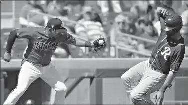  ?? AP Photo/Ross D. Franklin ?? Kansas City Royals’ Bubba Starling, right, steals third base as Arizona Diamondbac­ks third baseman Eduardo Escobar, left, reaches to apply a late tag during a spring training game Monday in Scottsdale, Ariz.