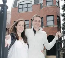  ?? CHARLES REX ARBOGAST/THE ASSOCIATED PRESS ?? Emily and Brian Townsend outside their home where they own the top floor unit in a three-flat building in Chicago. The couple was surprised by the hidden costs.