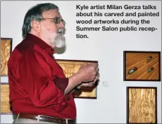  ??  ?? Kyle artist Milan Gerza talks about his carved and painted wood artworks during the Summer Salon public reception.