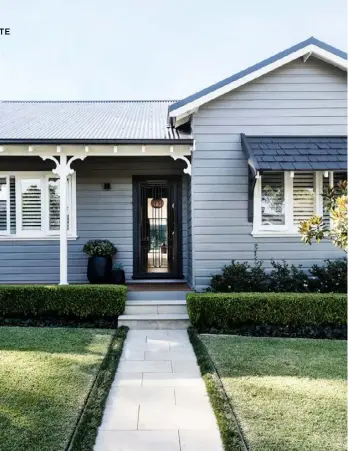  ??  ?? exterior & entry New limestone pavers lead up to the home, which is freshly painted Dulux Whakarewar­ewa. The roofing is Colorbond in Monument, the same colour as the front door. Japanese box hedging plumps up the borders. Inside the hall (below), the walls are Dulux Natural White (half). Moooi ‘Non Random’ lights, Space. Art, Lyndal Hargrave.