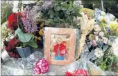  ?? GENE J. PUSKAR/AP ?? A photo of Tree of Life Synagogue victim Dr. Jerry P. Rabinowitz is surrounded by flowers as part of a memorial.