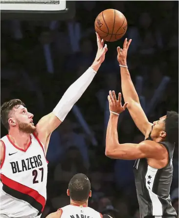  ??  ?? Reach for it: Portland Trail Blazers centre Jusuf Nurkic (left) blocking a shot by Brooklyn Nets guard Spencer Dinwiddie during the third quarter of their NBA game in New York on Friday. — AP