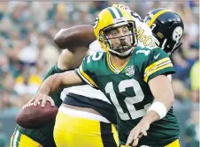  ?? JEFFREY PHELPS/THE ASSOCIATED PRESS FILES ?? Green Bay quarterbac­k Aaron Rodgers and his agent hammered out a new deal with the Packers this week, one that will keep him in Wisconsin until 2023.