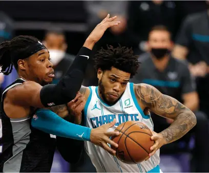  ?? Tribune News Service/getty Images ?? The Charlotte Hornets’ Miles Bridges, right, works under pressure from the Sacramento Kings’ Richaun Holmes at Golden 1 Center in Sacramento, California, on Sunday, Feb. 28. The Hornets won 127-126.