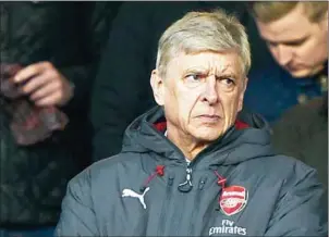  ?? OLI SCARFF/AFP ?? Arsenal Manager Arsene Wenger looks on from the stands during their FA Cup match with Nottingham Forest at The City Ground in Nottingham on Sunday.