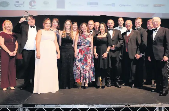  ??  ?? Bennetts Tower Cranes collect their Growth Business of the Year award from Sarah Danson of Growth Hub