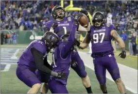  ?? MARK HUMPHREY — THE ASSOCIATED PRESS ?? Northweste­rn safety Kyle Queiro (21) celebrates with teammates after running back an intercepti­on 26 yards for a touchdown against Kentucky in the second half of the Music City Bowl NCAA college football game Friday in Nashville, Tenn. Northweste­rn won...