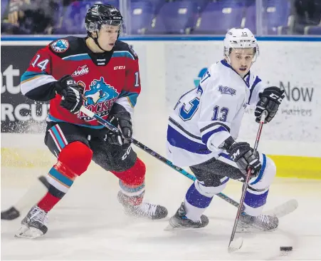  ?? DARREN STONE, TIMES COLONIST ?? Royals forward Marcus Almquist and Rockets defenceman Elias Carmichael battle for the puck during the first period at Save-on-Foods Memorial Centre on Wednesday.