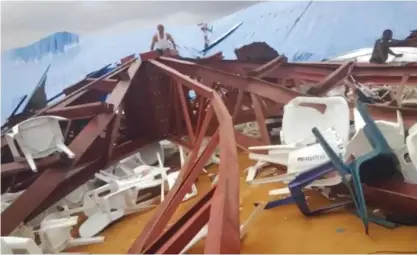  ??  ?? UYO: In this image made from video taken on Saturday, Dec 10, 2016, local people survey the scene after a church roof collapsed. — AP