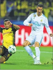  ??  ?? Real Madrid's forward from Portugal Cristiano Ronaldo scores during the UEFA Champions League Group H football match against Dortmund