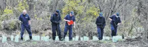  ?? PHOTO: GREGOR RICHARDSON ?? On the trail . . . Members of a specialist police search team from Christchur­ch pick their way through rough ground near Bortons Pond near Duntroon yesterday afternoon.