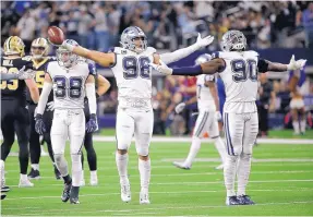  ?? RON JENKINS/ASSOCIATED PRESS ?? Dallas safety Jeff Heath (38), defensive tackle Tyrone Crawford (98) and defensive end Demarcus Lawrence (90) celebrate a big play during the team’s Nov. 29 win over N.O.