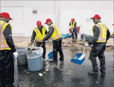  ?? Photograph­s by Jay L. Clendenin Los Angeles Times ?? WORKERS clear discarded items on Ceres Avenue. The Downtown Los Angeles Neighborho­od Council has voted to ask the mayor and the fire chief for “appropriat­e funds and manpower” to deal with the fire risk.