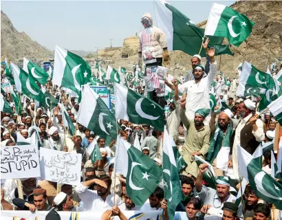  ?? AP ?? Pakistani tribal people rally against the United States in Torkham, a border town along the Afghanista­n border, on Monday. Protesters have rejected US President Donald Trump’s allegation that Islamabad is harbouring militants who kill US soldiers in...