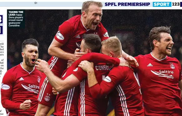  ??  ?? TAKING THE
LEAD: happy Dons players crowd round goalscorer Considine