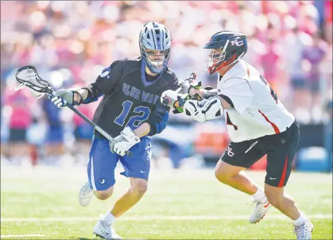  ?? Matthew Brown / Hearst Connecticu­t Media ?? Darien’s Tommy Hellman moves upfield against New Canaan’s Christian Sweeney during game at Duning Field on May 11 in New Canaan.