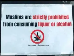  ??  ?? A sign prohibitin­g Muslim visitors from purchasing alcoholic drinks at the fair.