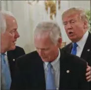 ??  ?? President Donald Trump stops to greet Senate Majority Whip John Cornyn of Texas, left, and Sen. Ron Johnson, R-Wis. at a luncheon with GOP leadership, Wednesday, July 19, 2017, in the State Dinning Room of the White House in Washington.
