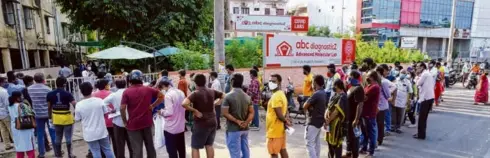  ??  ?? PEOPLE WAITING outside a private COVID testing centre, in Vijayawada on May 1.