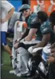  ?? MICHAEL AINSWORTH — THE ASSOCIATED PRESS ?? Eagles quarterbac­k Carson Wentz (11) sits on the bench during the first half of Sunday’s loss to the Cowboys.