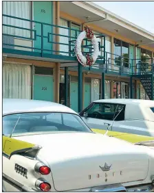  ?? National Civil Rights Museum ?? Old cars sit parked beneath the motel balcony on which Martin Luther King Jr. was standing when he was assassinat­ed on April 4, 1968. The National Civil Rights Museum surrounds the old motel.