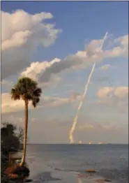  ?? MALCOLM DENEMARK — FLORIDA TODAY VIA AP ?? A United Launch Alliance Atlas V rocket lifts off from Cape Canaveral Air Force Station in Florida, seen from KARS Park on Merritt Island, near Cocoa Bean, Fla., Thursday. NASA launched another of the world’s most advanced weather satellites on...