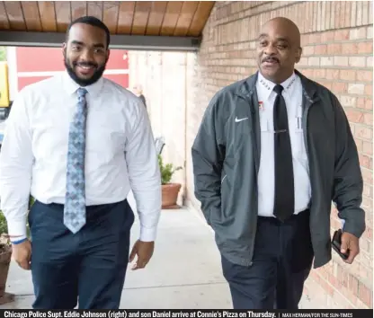  ??  ?? Chicago Police Supt. Eddie Johnson ( right) and son Daniel arrive at Connie’s Pizza on Thursday. | MAX HERMAN/ FOR THE SUN- TIMES