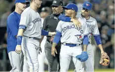  ?? MICHAEL HICKEY/GETTY IMAGES ?? Toronto Blue Jays’ pitcher Marcus Stroman is restrained by teammates and officials after a confrontat­ion with the Chicago White Sox dugout at Guaranteed Rate Field on Tuesday, in Chicago.