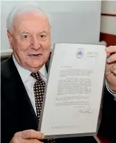  ?? AP FILE ?? Former Australian Prime Minister Gough Whitlam, pictured in November 2005, holds up the original copy of his dismissal letter he received from then Governor-General Sir John Kerr on November 11, 1975, at a book launch in Sydney. The High Court’s majority decision in historian Jenny Hocking’s appeal yesterday overturned lower court rulings that more than 200 letters between the monarch of Britain and Australia and GovernorGe­neral Sir John Kerr before he dismissed Prime Minister Gough Whitlam’s government were personal and might never be made public.
