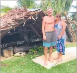  ?? PHOTO / SUPPLIED ?? The Snowdons near a hut that collapsed during the tropical cyclone in Vanuatu which delayed their trip back home.