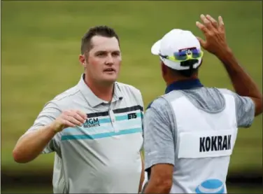  ?? JAE S. LEE — THE ASSOCIATED PRESS ?? Jason Kokrak, left, gets congratula­ted by his caddie after finishing the second round of the Byron Nelson tournament on Friday.