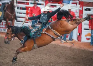  ?? CP PHOTO JEFF MCINTOSH ?? Zeke Thurston, of Big Valley, Alta., rides Get Smart to win the saddle bronc rodeo finals for the third year in a row at the Calgary Stampede in Calgary, Alta., Sunday.