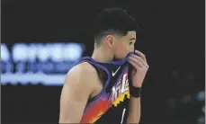  ?? AP PHOTO/MATT YORK ?? Phoenix Suns guard Devin Booker looks towards his bench during the second half of Game 7 of an NBA basketball Western Conference playoff semifinal against the Dallas Mavericks, on Sunday in Phoenix.