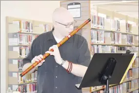  ?? Rachel Dickerson/The Weekly Vista ?? Marc Paine of Bella Vista plays a honkyoku on the Xindi during his “Sounds of Spring” performanc­e at the Bella Vista Public Library on Tuesday, March 7. Two performanc­es remain in the month of March.
