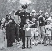  ?? CHRIS DILLMANN Vail Daily Mail ?? People pay their respects during the presentati­on of the Colors and national anthem Saturday in Edwards, Colo.