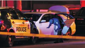  ?? IAN KUCERAK / POSTMEDIA ?? Edmonton police investigat­e after a man struck an officer with a car Saturday evening. The suspect then ran over four others with a U-Haul van before being stopped.