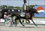  ?? BILL KOSTROUN — THE ASSOCIATED PRESS FILE ?? In this file photo, Glidemaste­r, driven by John Campbell, wins the Hambletoni­an at Meadowland­s Racetrack in East Rutherford, N.J. Campbell bids farewell to the Meadowland­s, making his final drives at the track that helped the Hall of Famer become...