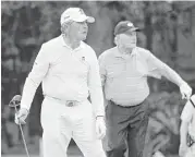  ?? Michael Wyke ?? Gary Player, left, and Jack Nicklaus check the 10th fairway for an ideal landing spot before teeing off.