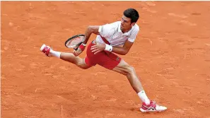  ?? AP Photo/Christophe Ena ?? ■ Serbia’s Novak Djokovic keeps his eye on the ball as he returns a shot against Brazil’s Rogerio Dutra Silva during their first-round French Open match Monday at Roland Garros stadium in Paris. Djokovic—a former No. 1 now ranked 22nd, his worst spot since 2006—beat the 134th-ranked qualifier Silva, quickly recovering after dropping the opening two games.