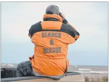  ?? ERIC MCCARTHY/JOURNAL PIONEER ?? A search and rescue member scans the horizon Wednesday for any sign of the two West Prince fishermen who are missing after their vessel capsized in the Gulf of St. Lawrence Tuesday.