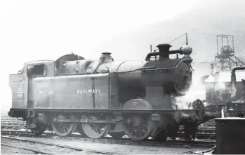  ??  ?? Murk hanging over Treherbert on 4 May 1951 aids what would ordinarily be a view into the sun, the subject being ‘A’ class 0-6-2T No 366 branded ‘BRITISH RAILWAYS’, complete with the backdrop provided by the pithead of Lady Margaret Colliery. John Cameron succeeded Hurry Riches as TVR locomotive superinten­dent in 1912 and the class ‘A’ was his mixed traffic contributi­on, albeit best suited to passenger work. Completed as Vulcan Foundry Works No 3183, it entered Taff Vale stock in August 1916 as No 132, becoming No 366 as a Great Western asset. The engine is seen with a Standard No 10 boiler – its first was gained in March 1929 – and it became a regular fixture at Treherbert, this view being recorded between duties at its home shed. The class would lose work to the BR Standard ‘3MT’ 2-6-2Ts from 1953, the demise of No 366 in October 1955 being fairly typical for the class.