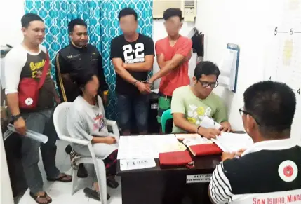  ?? — Contribute­d Photo ?? BUSTED. Suspected drug pusher Marites Quizon and suspected users Albert and Jayson Navarro undergo booking procedures after they were arrested during a buy bust operation by police operatives led by P/Chief Inspector Pearl Joy Gollayan at san Isidro,...