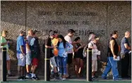  ?? AP PHOTO BY RICHARD VOGEL ?? In this Tuesday, Aug. 7, photo people line up outside the offices of California’s Department of Motor Vehicles, DMV Van Nuys offices in Los Angeles.