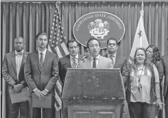  ??  ?? Associated Press Assemblyme­mber David Chiu, D-San Francisco, chair of the Assembly Committee on Housing and Community Developmen­t, center at podium, speaks Friday during a news conference in Los Angeles.