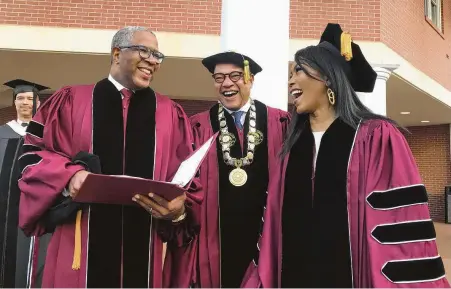  ?? Bo Emerson / Associated Press ?? Robert F. Smith, left, laughs with Morehouse President David Thomas and actress Angela Bassett at the school’s commenceme­nt. The billionair­e technology investor said he will provide grants to wipe out the student debt of the entire graduating class.