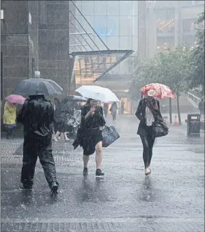  ??  ?? BOLDLY GOING ... Shoppers brave the deluge in Glasgow’s Sauchiehal­l Street.