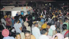  ?? HT PHOTO ?? Congress supporters and people outside the hospital where party councillor Gurdeep Singh (below) was shifted after three assailants opened fire at him, in Amritsar on Saturday.