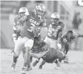  ?? MICHAEL LAUGHLIN/SUN SENTINEL ?? Alabama Birmingham receiver Andre Wilson gains a first down against Northern Illinois during the game at FAU.