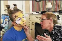  ?? CONTRIBUTE­D PHOTOS - FALLS VILLAGE CHILDREN’S THEATER ?? Artist Beth Miller paints Maguerite Bickford’s face in preparatio­n for “Madagascar,” which is being presented by Falls Village Children’s Theater March 31-April 2.