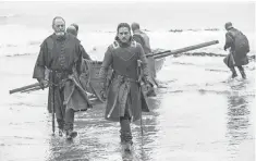  ?? HBO ?? Davos (Liam Cunningham) and Jon (Kit Harington) arrive at Dragonston­e after a seemingly uneventful trip on